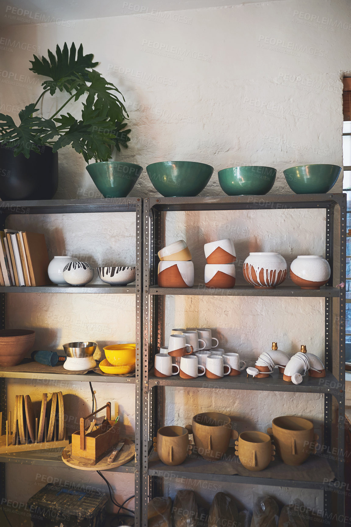 Buy stock photo Shot of various vases and pots on a shelf in a pottery studio