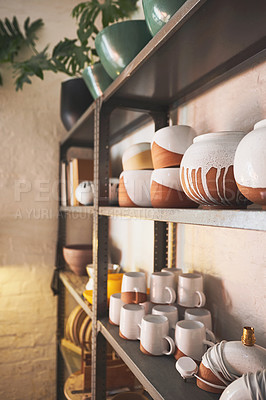 Buy stock photo Shot of various vases and pots on a shelf in a pottery studio