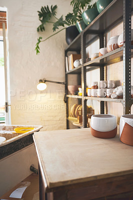 Buy stock photo Shot of various vases and pots on a shelf in a pottery studio