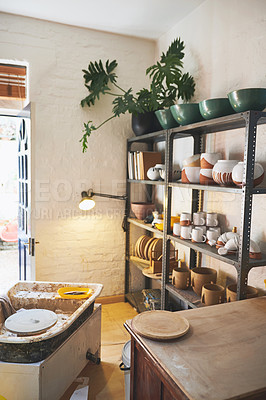 Buy stock photo Shot of various vases and pots on a shelf in a pottery studio