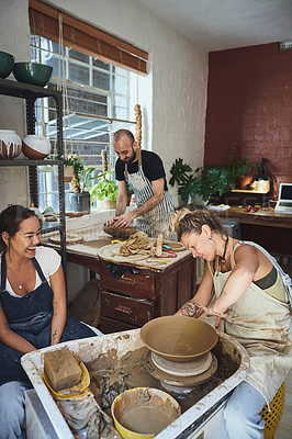 Buy stock photo Shot of a group of young people working with clay in a pottery studio