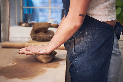 Buy stock photo Shot of an unrecognisable woman kneading clay in a pottery studio