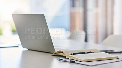 Buy stock photo Closeup shot of a laptop and notebook on a desk in an office