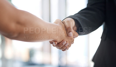 Buy stock photo Closeup shot of two unrecognisable businesswomen shaking hands in an office