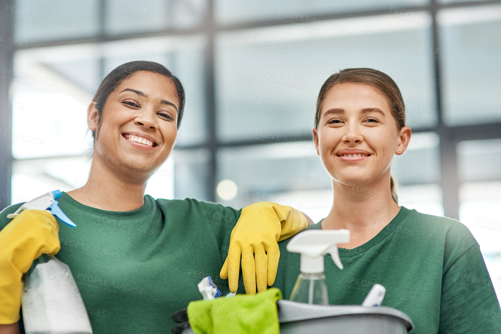 Buy stock photo Portrait of two young woman cleaning a modern office