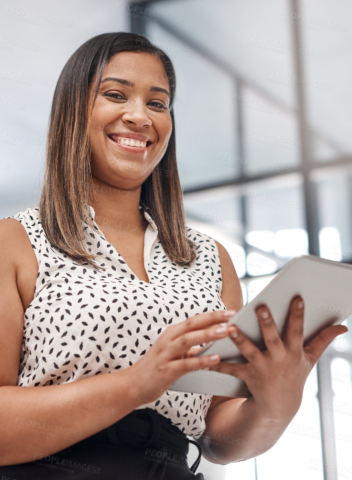 Buy stock photo Portrait of a young businesswoman using a digital tablet in an office