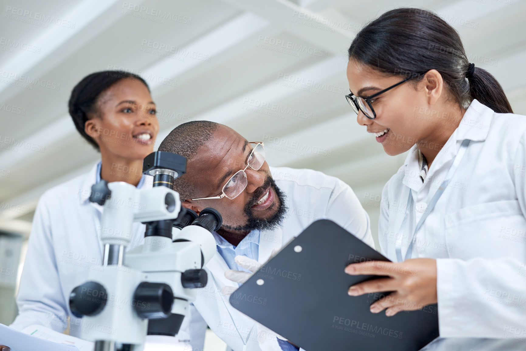 Buy stock photo Shot of a group of scientists working together in a lab