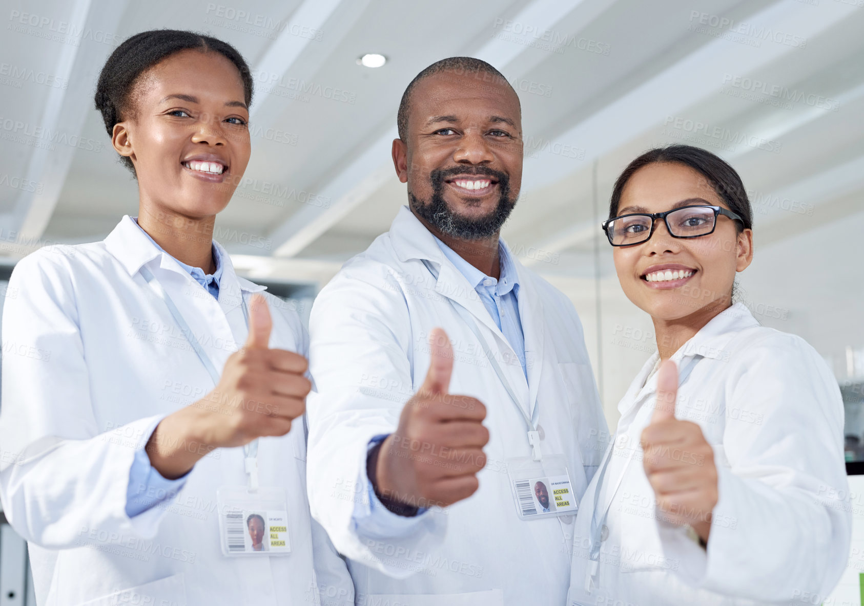 Buy stock photo Portrait of a group of scientists showing thumbs up in a lab