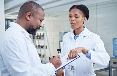 Buy stock photo Shot of two scientists having a discussion in a lab