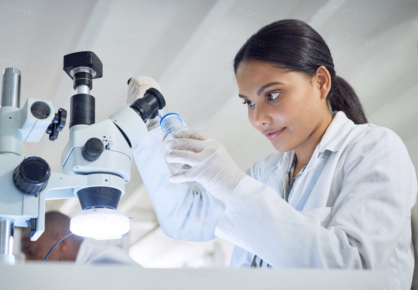 Buy stock photo Shot of a young scientist working in a lab