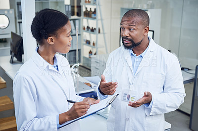 Buy stock photo Shot of two scientists having a discussion in a lab