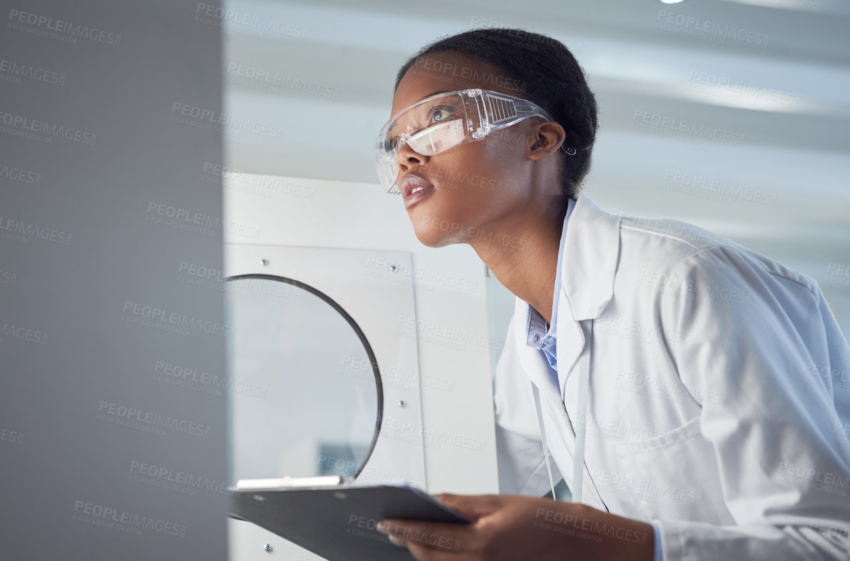 Buy stock photo Shot of a young scientist working in a lab