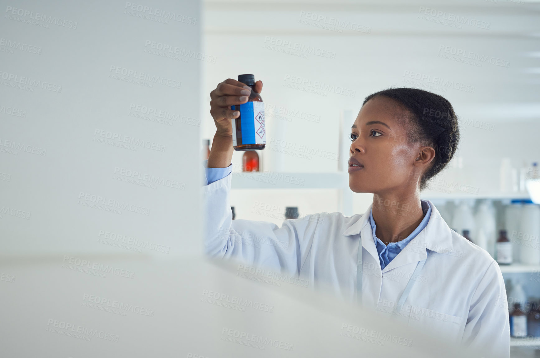 Buy stock photo Shot of a young scientist working in a lab