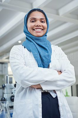 Buy stock photo Portrait of a young scientist standing with her arms crossed in a lab