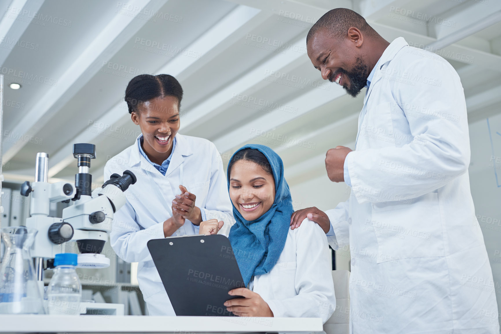 Buy stock photo Shot of a group of scientists cheering while working in a lab