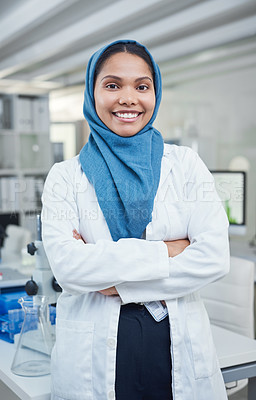 Buy stock photo Portrait of a young scientist standing with her arms crossed in a lab