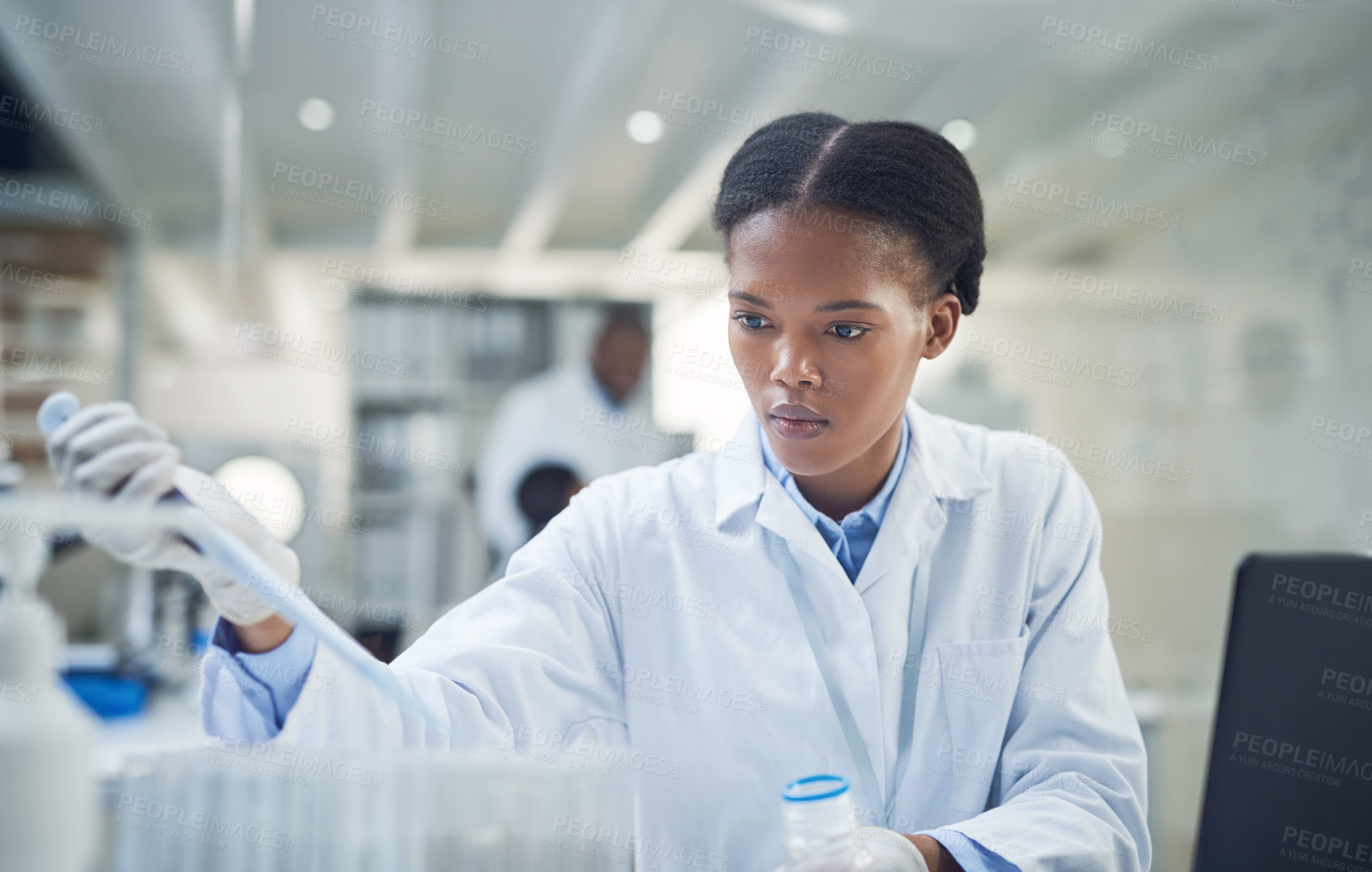 Buy stock photo Shot of a young scientist working in a lab