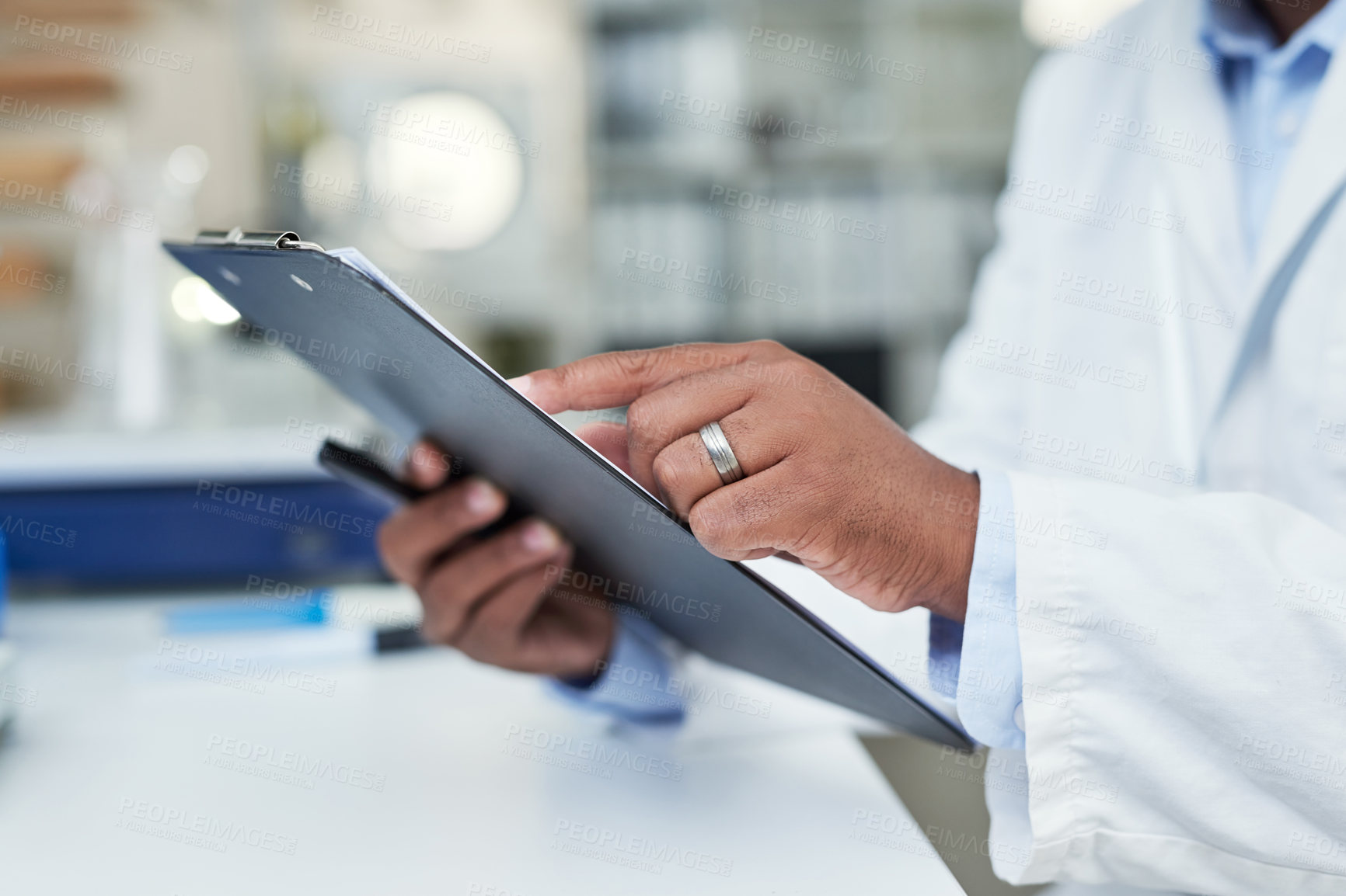 Buy stock photo Closeup shot of an unrecognisable scientist holding a clipboard in a lab