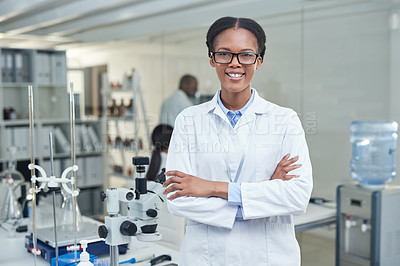 Buy stock photo Portrait of a young scientist standing with her arms crossed in a lab