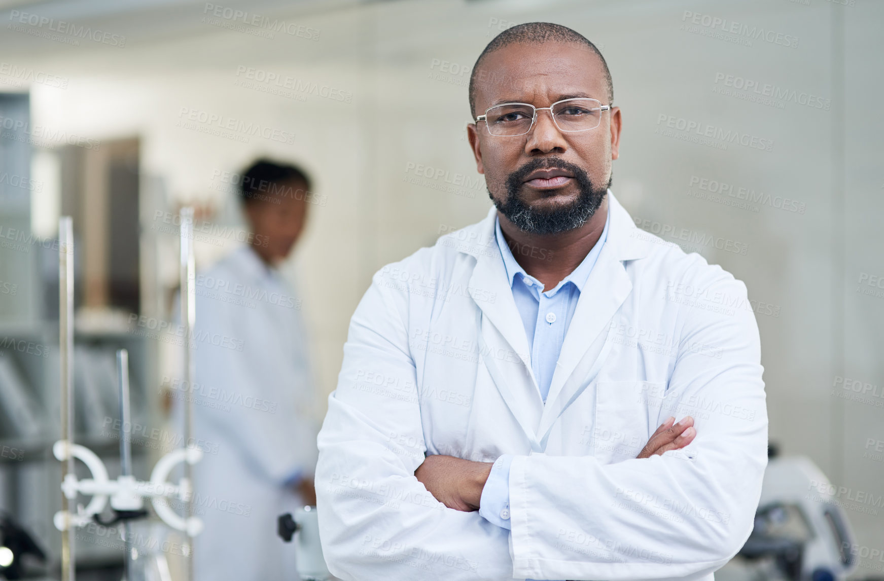 Buy stock photo Portrait of a mature scientist standing with his arms crossed in a lab