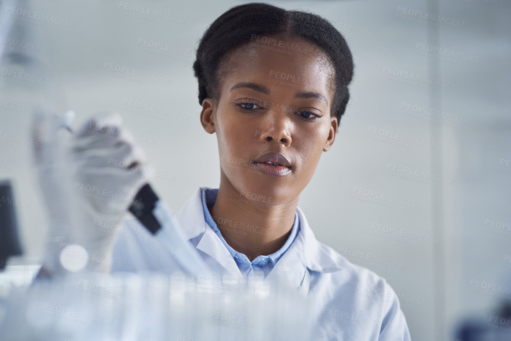 Buy stock photo Shot of a young scientist working in a lab