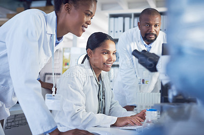 Buy stock photo Shot of a group of scientists working together in a computer in a lab