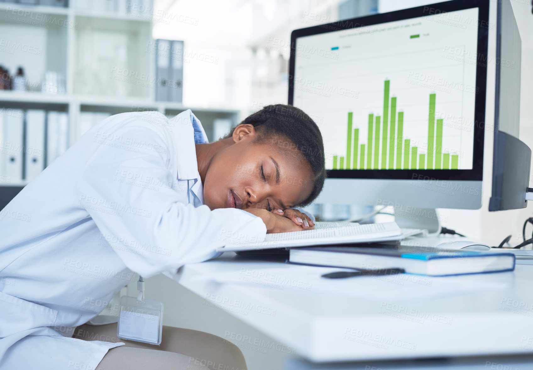 Buy stock photo Shot of a young scientist sleeping at her desk while conducting research in a laboratory