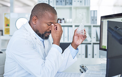 Buy stock photo Shot of a scientist looking stressed while conducting research in a laboratory