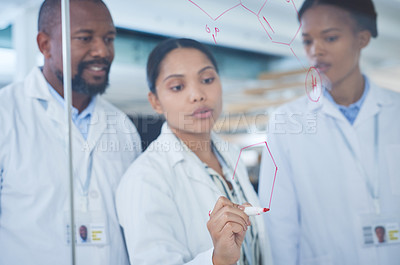 Buy stock photo Shot of a group of scientists having a brainstorming session in a laboratory
