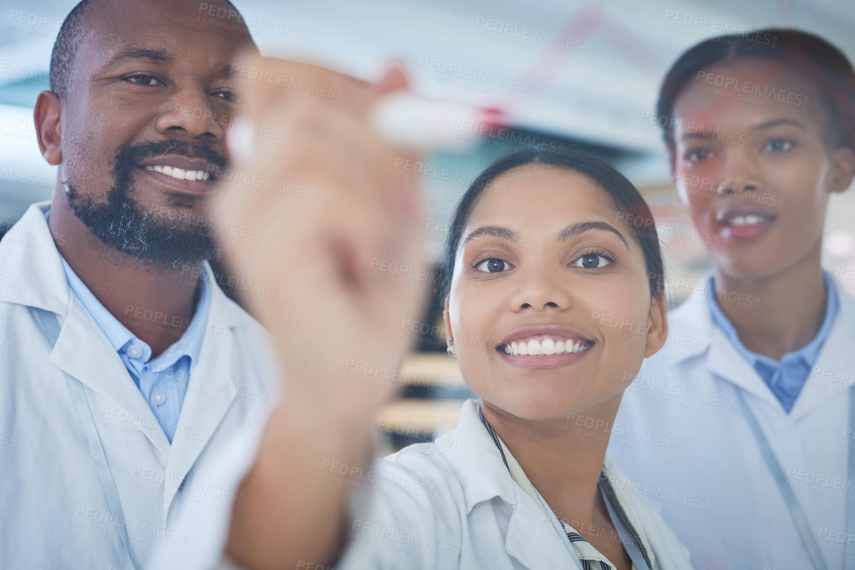 Buy stock photo Shot of a group of scientists having a brainstorming session in a laboratory