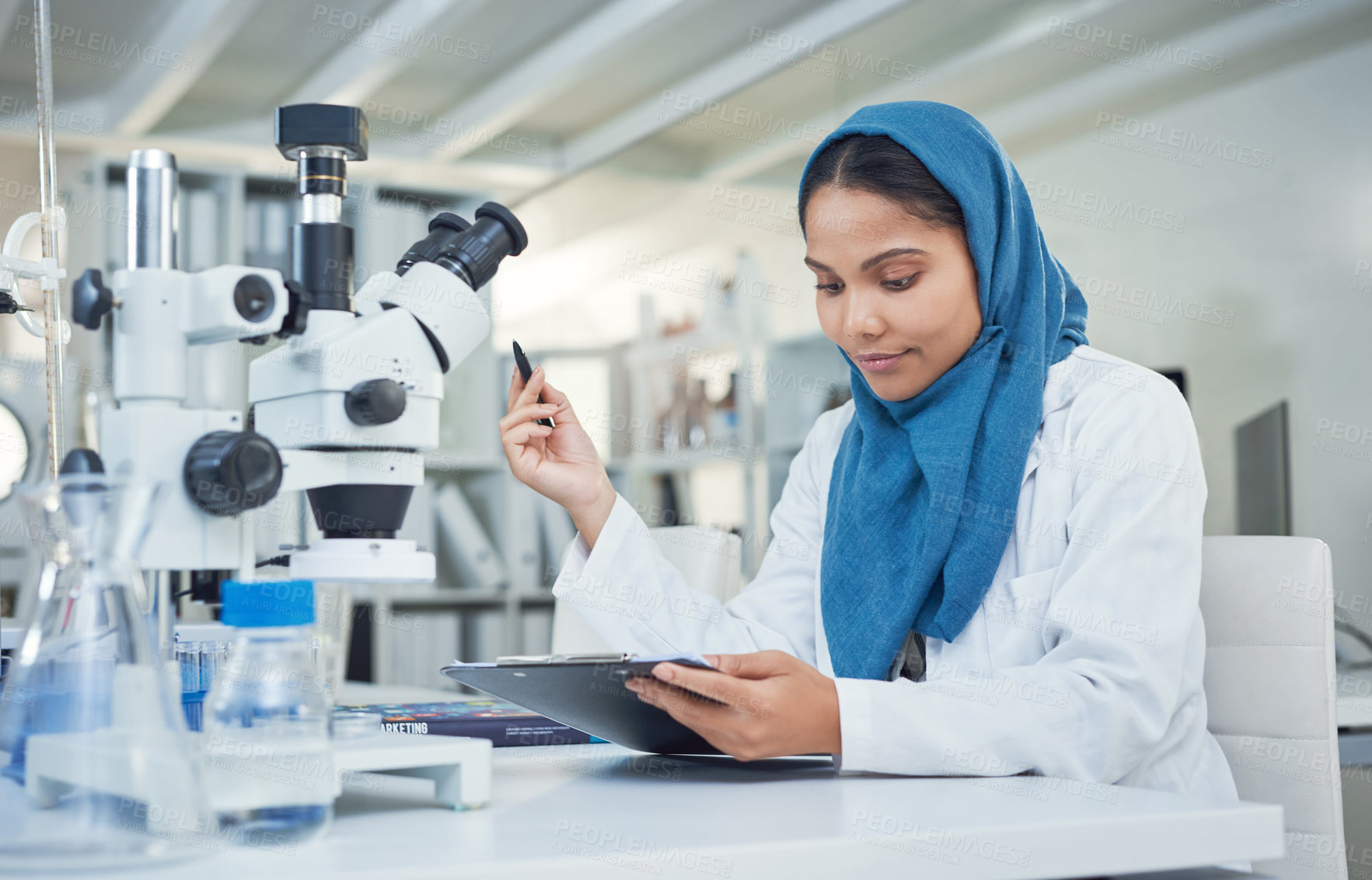 Buy stock photo Shot of a young scientist conducting research in a laboratory