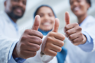 Buy stock photo Shot of a group of scientists showing thumbs up while conducting research in a laboratory