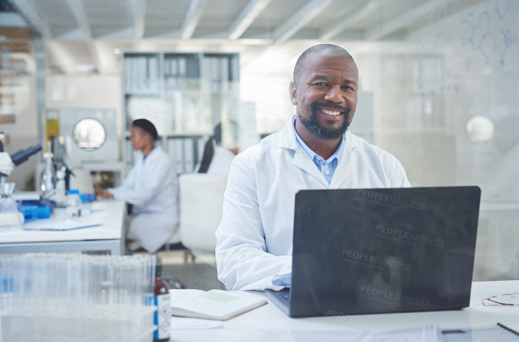 Buy stock photo Shot of a confident scientist using a laptop to conduct research in a laboratory