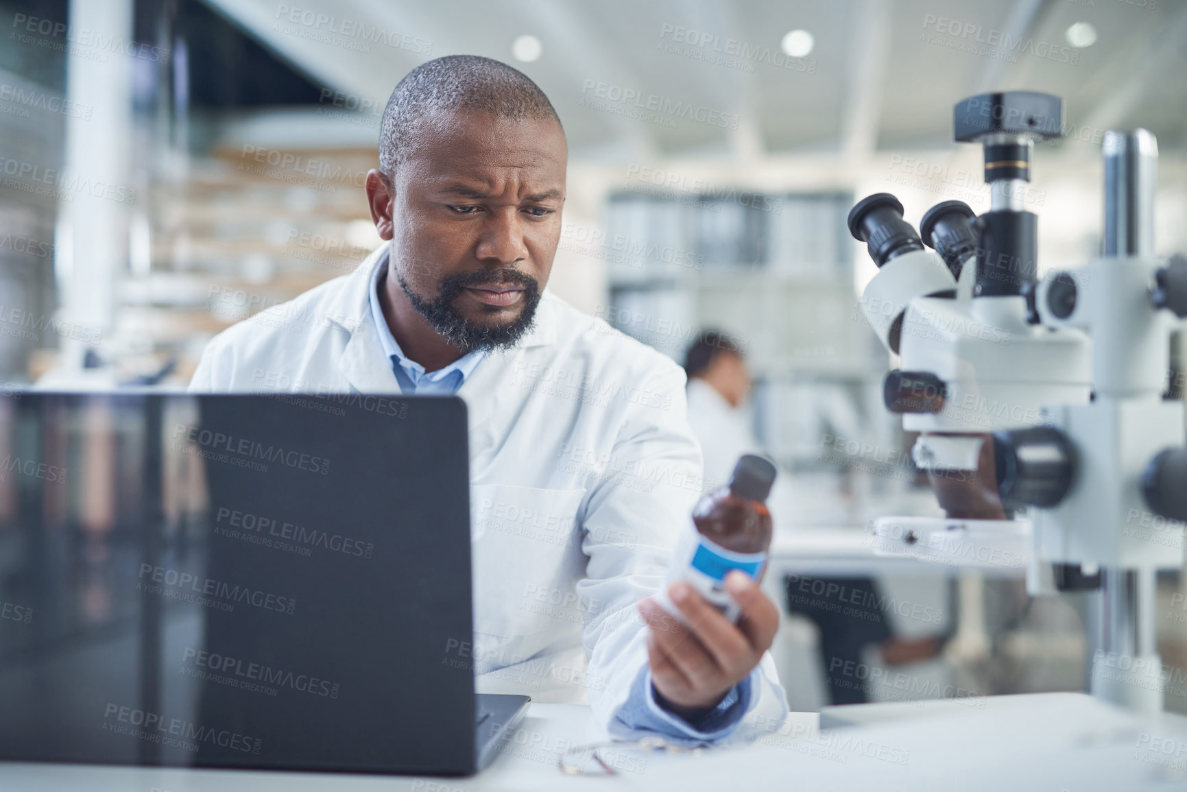 Buy stock photo Shot of a scientist using a laptop to conduct research in a laboratory
