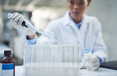 Buy stock photo Shot of a young scientist conducting research in a laboratory