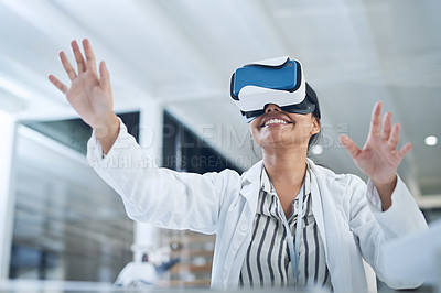Buy stock photo Shot of a young scientist using a virtual reality headset while conducting research in a laboratory
