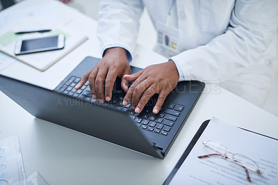 Buy stock photo Shot of an unrecognisable scientist using a laptop to conduct research in a laboratory