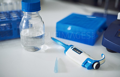 Buy stock photo Shot of various scientific testing tools on a table in a laboratory