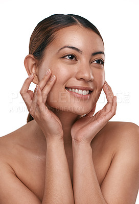 Buy stock photo Shot of a beautiful young woman touching her face while standing against a white background