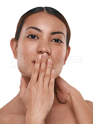 Buy stock photo Shot of a beautiful young woman holding her hand over her mouth