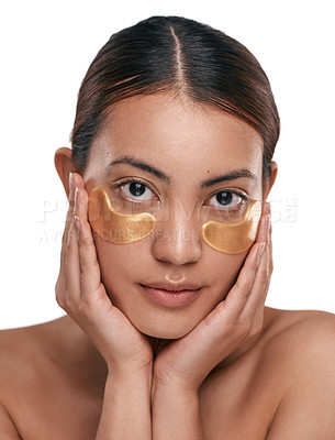 Buy stock photo Shot of a beautiful young woman wearing gold patches under her eyes