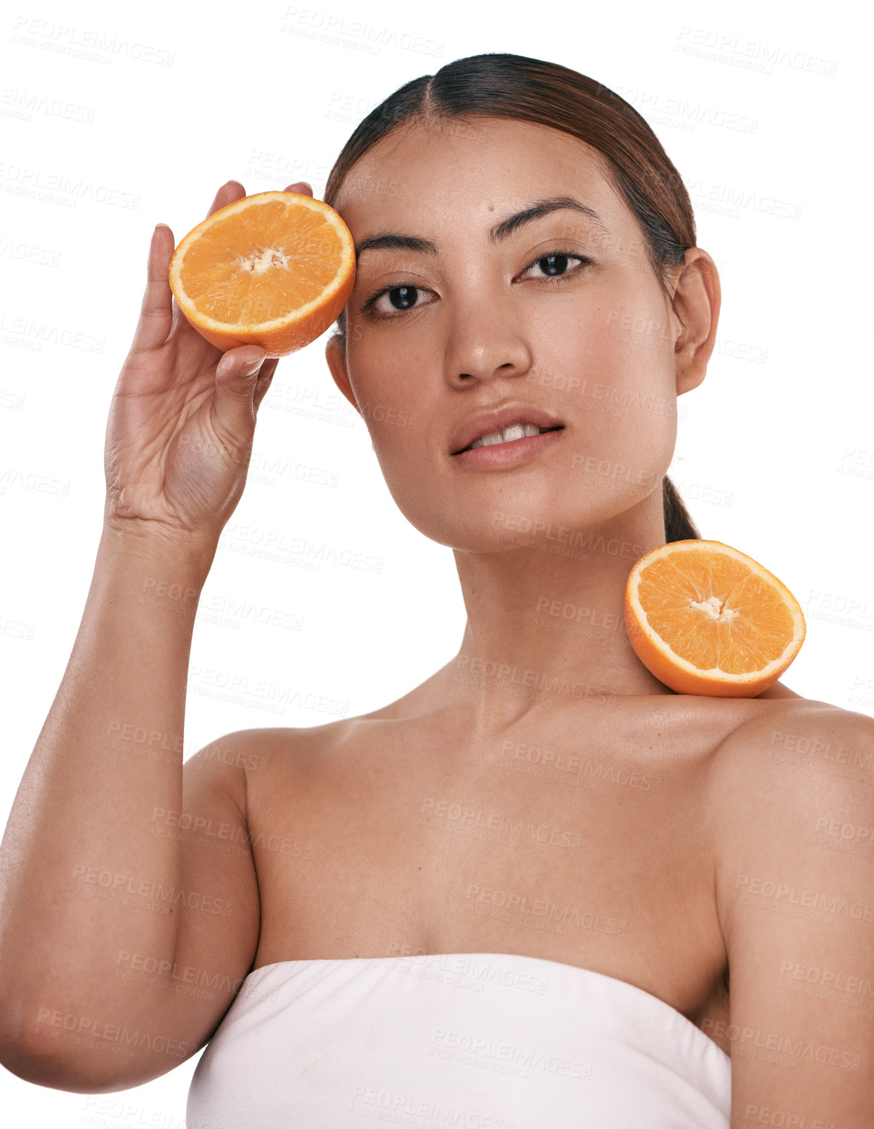 Buy stock photo Shot of a beautiful young woman posing with halved oranges against her skin