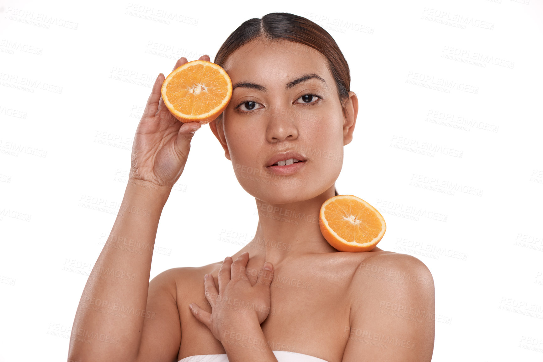 Buy stock photo Shot of a beautiful young woman posing with halved oranges against her skin