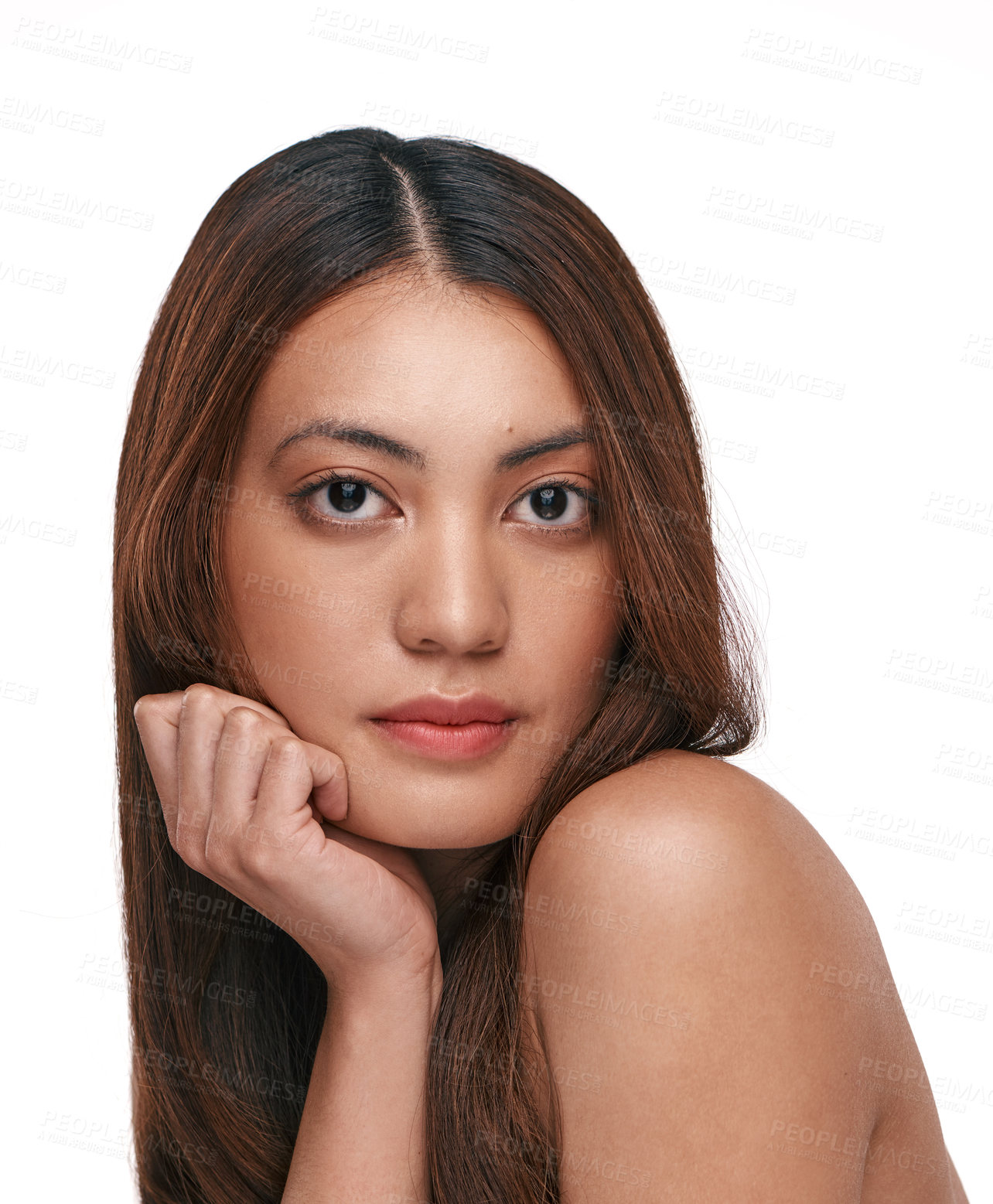 Buy stock photo Studio shot of a beautiful young woman with long brown hair against a white background