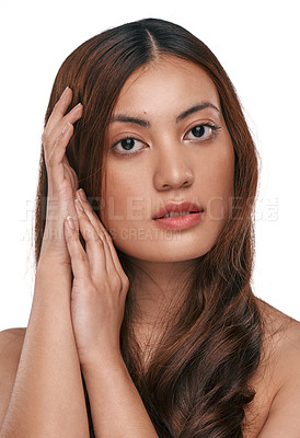 Buy stock photo Studio shot of a beautiful young woman with long brown hair against a white background
