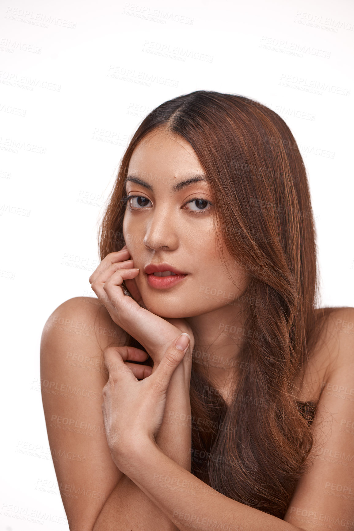 Buy stock photo Studio shot of a beautiful young woman with long brown hair against a white background