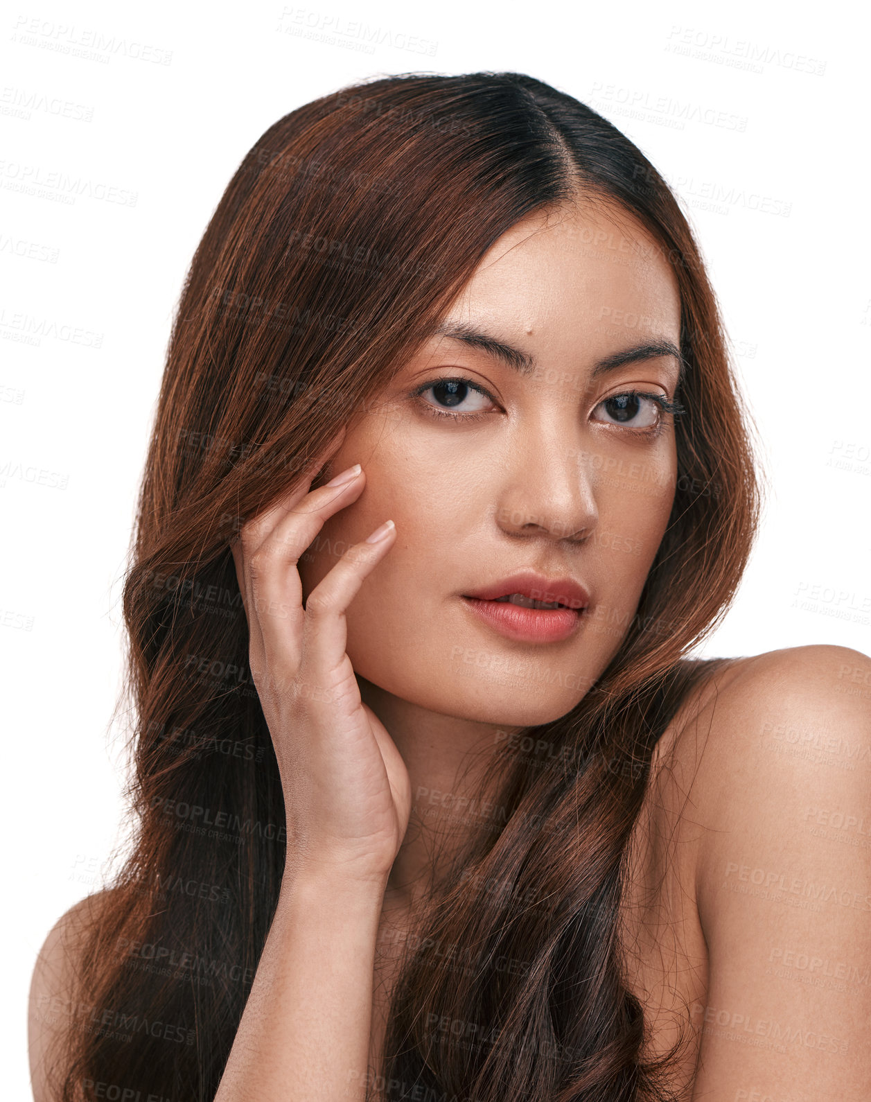 Buy stock photo Studio shot of a beautiful young woman with long brown hair against a white background