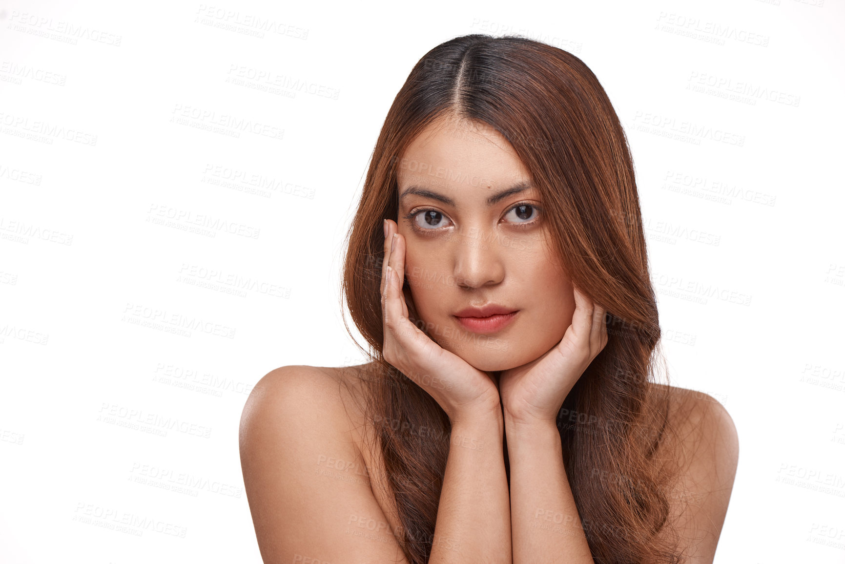 Buy stock photo Studio shot of a beautiful young woman with long brown hair against a white background