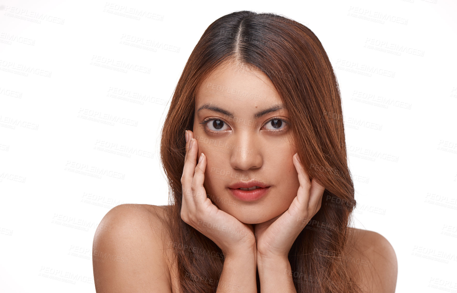 Buy stock photo Studio shot of a beautiful young woman with long brown hair against a white background