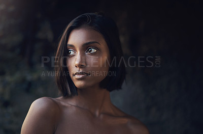 Buy stock photo Cropped shot of a beautiful young woman posing against a dark background